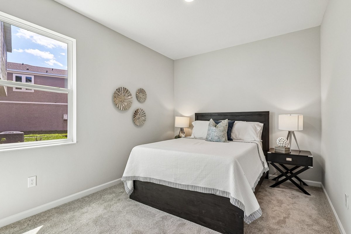 cozy-guest-bedroom-dark-wood-bed-frame-white-bedding-nightstands-carpet-flooring-5348-ctr-lk-rnch-blvd-st-cloud-fl