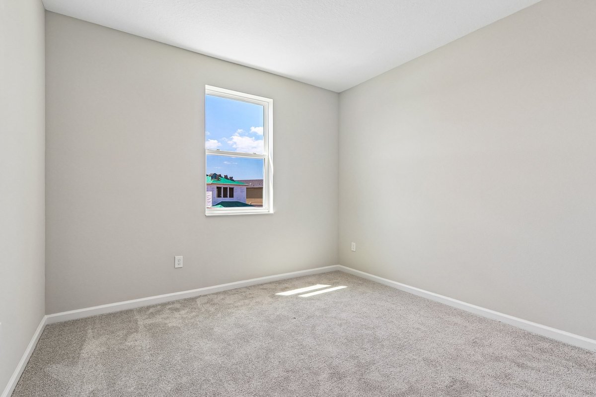 empty-bedroom-carpet-flooring-window-natural-light-neutral-walls-new-construction-5348-ctr-lk-rnch-blvd-st-cloud-fl