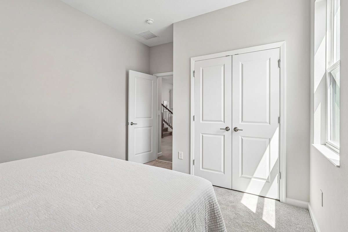 guest-bedroom-double-closet-doors-carpet-flooring-natural-light-neutral-walls-5348-ctr-lk-rnch-blvd-st-cloud-fl