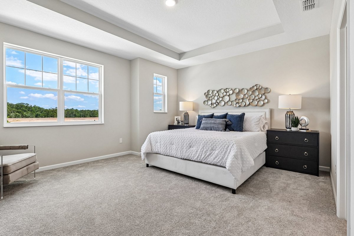 master-bedroom-tray-ceiling-king-bed-large-windows-carpet-flooring-natural-light-5348-ctr-lk-rnch-blvd-st-cloud-fl