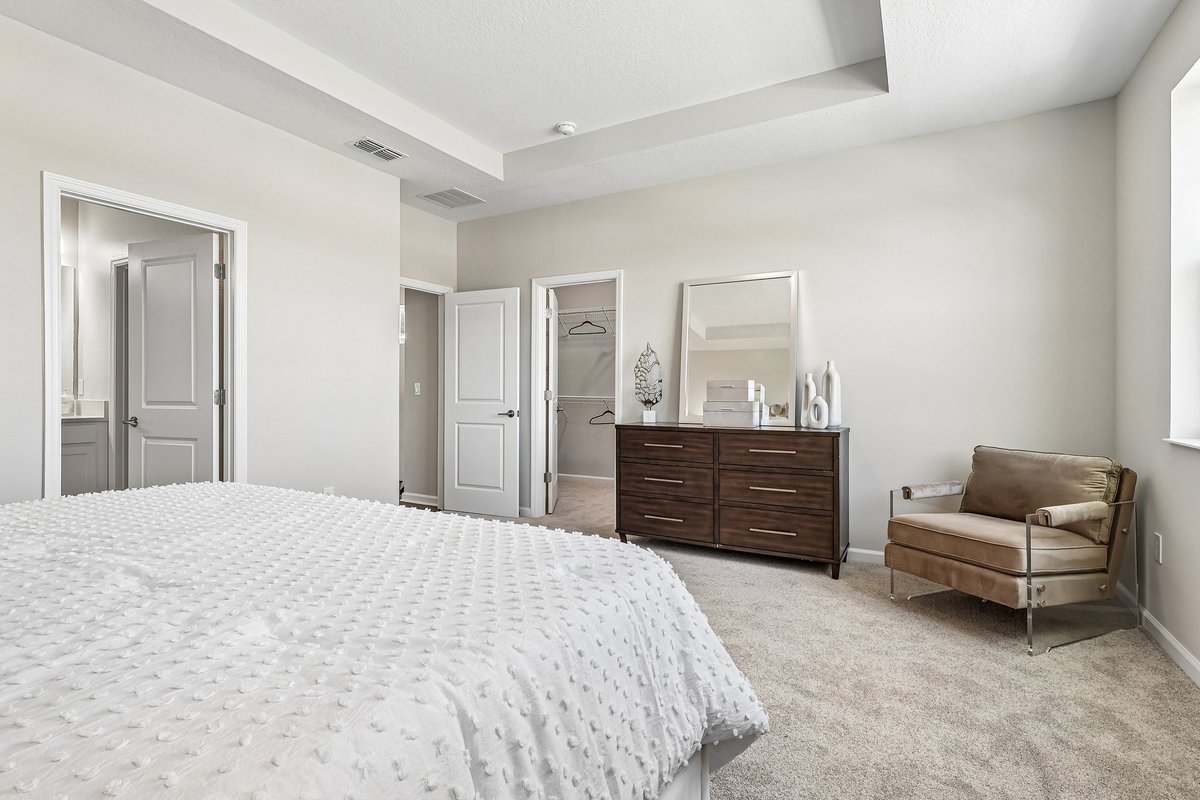 master-bedroom-walk-in-closet-ensuite-bathroom-tray-ceiling-wood-dresser-accent-chair-5348-ctr-lk-rnch-blvd-st-cloud-fl