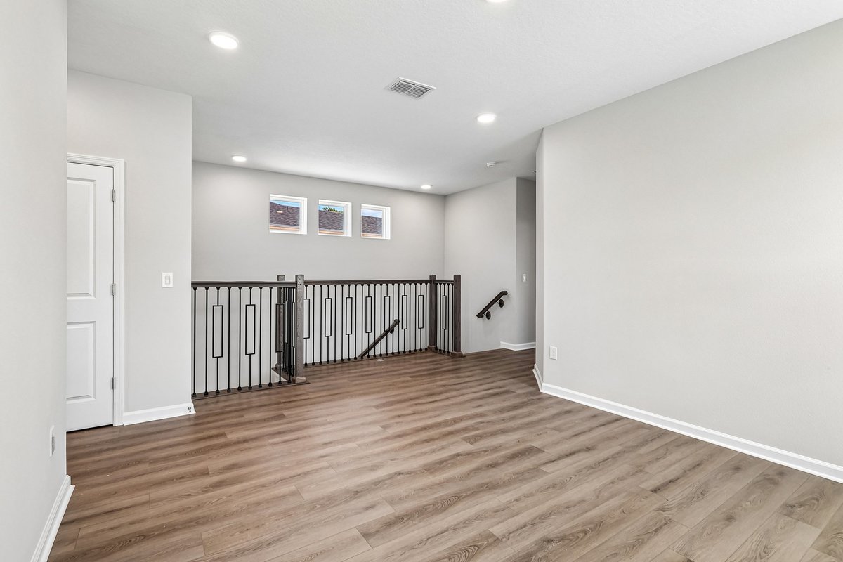 second-floor-loft-area-iron-baluster-railing-vinyl-plank-flooring-clerestory-windows-5348-ctr-lk-rnch-blvd-st-cloud-fl