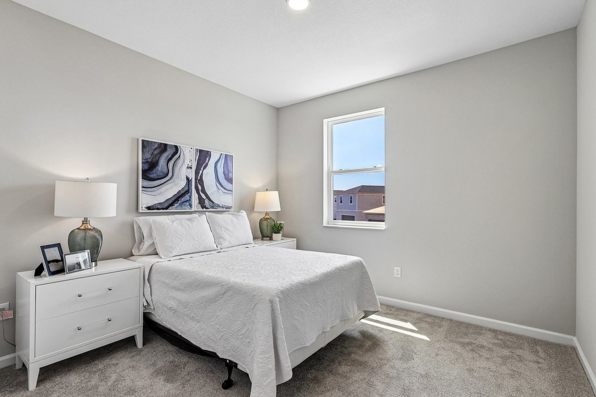 upstairs-guest-bedroom-queen-bed-white-nightstands-abstract-art-carpet-flooring-5348-ctr-lk-rnch-blvd-st-cloud-fl