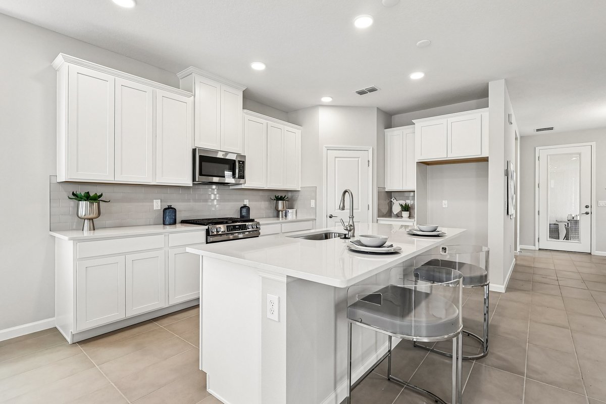 white-kitchen-quartz-countertop-island-with-bar-stools-gas-stove-subway-tile-backsplash-5348-ctr-lk-rnch-blvd-st-cloud-fl