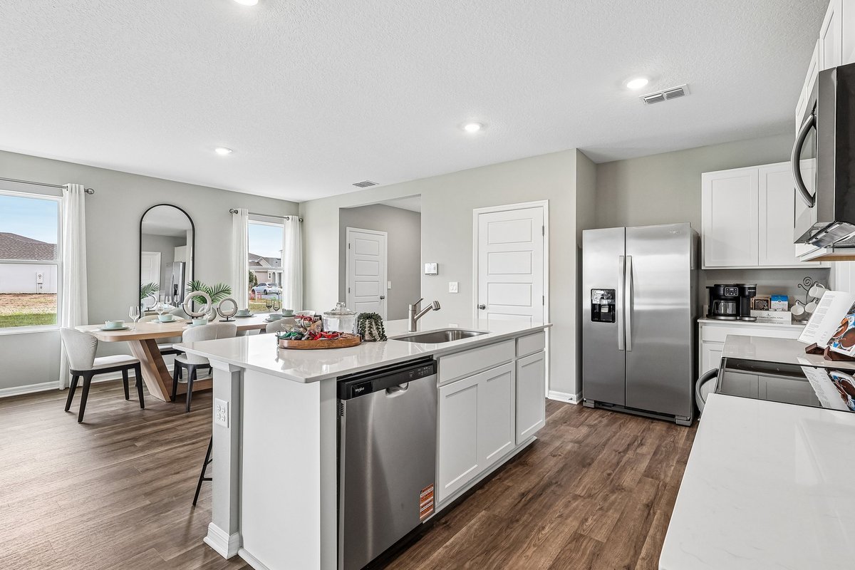 Modern kitchen with quartz countertops and a spacious island in a new construction home.