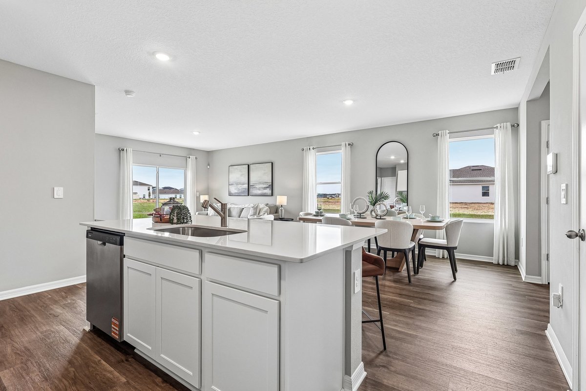 Large kitchen island with seating in a professionally staged model home.