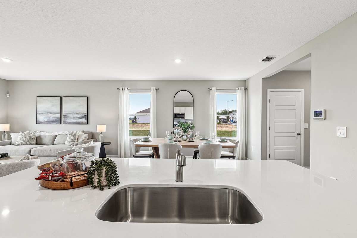 Large kitchen island with seating in a professionally staged model home.