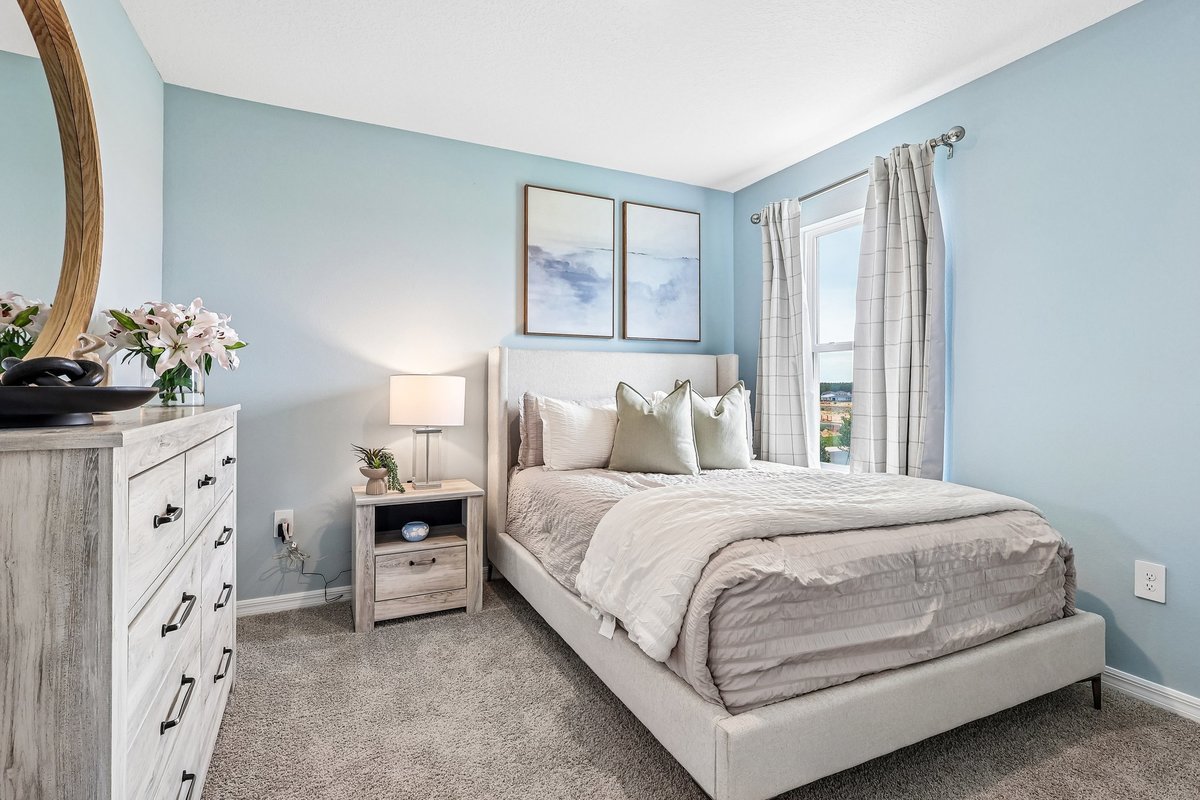 Modern guest bedroom with natural light and stylish décor.