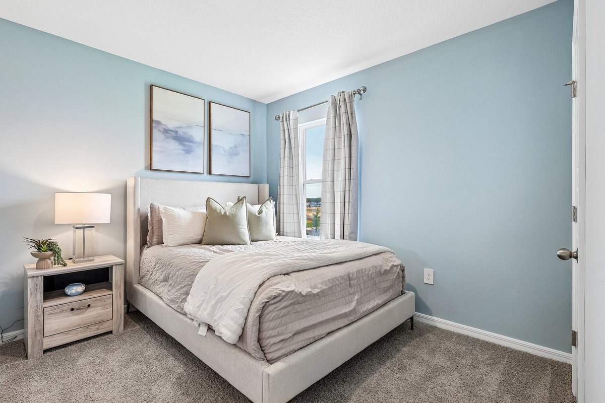 Guest bedroom designed with comfort and functionality in mind.