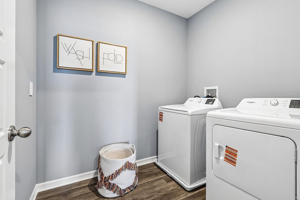 Functional laundry room inside a new construction model home.