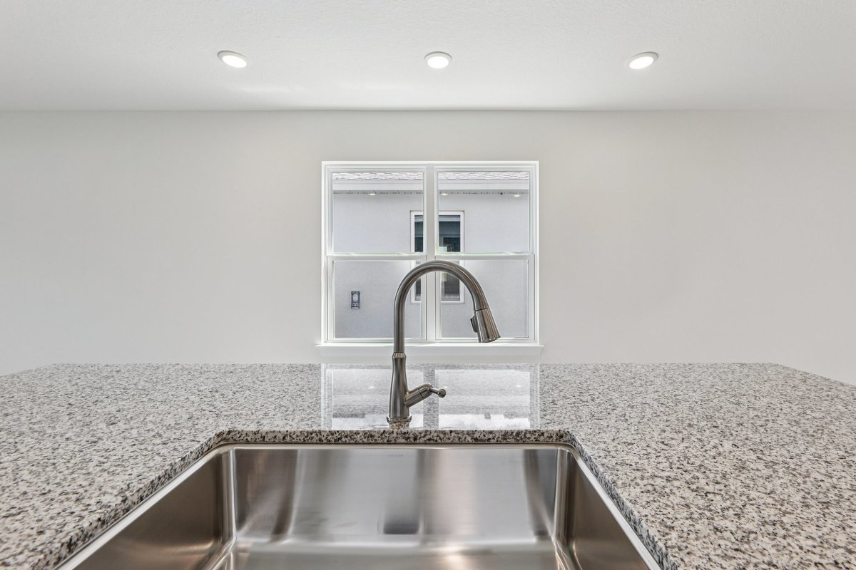 Kitchen island with granite countertop in new construction home
