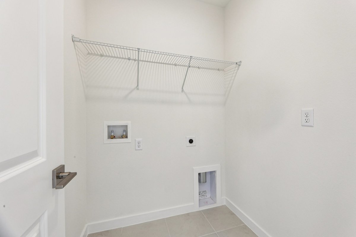 Laundry room with wire shelving in new construction home