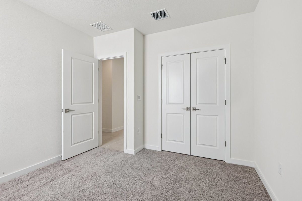 Bright bedroom with natural light and tray ceiling in Winter Haven FL