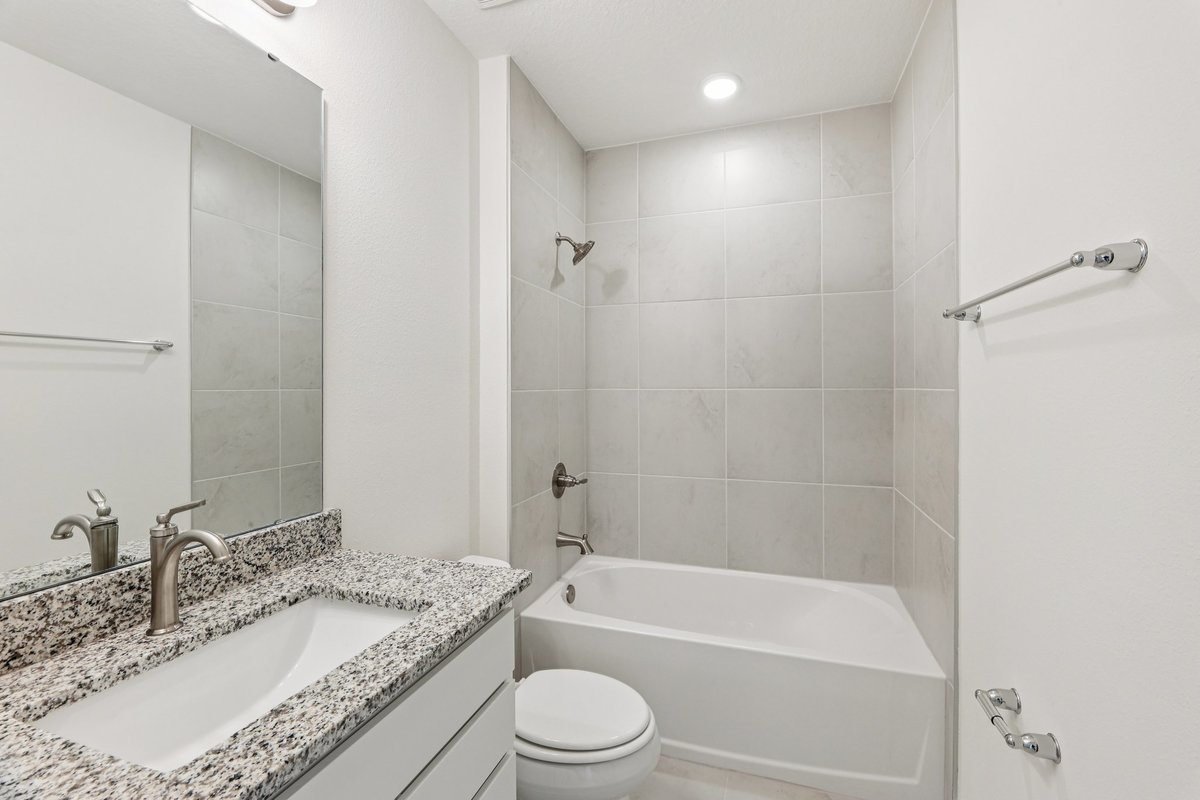 Bathroom with granite countertop and double sink