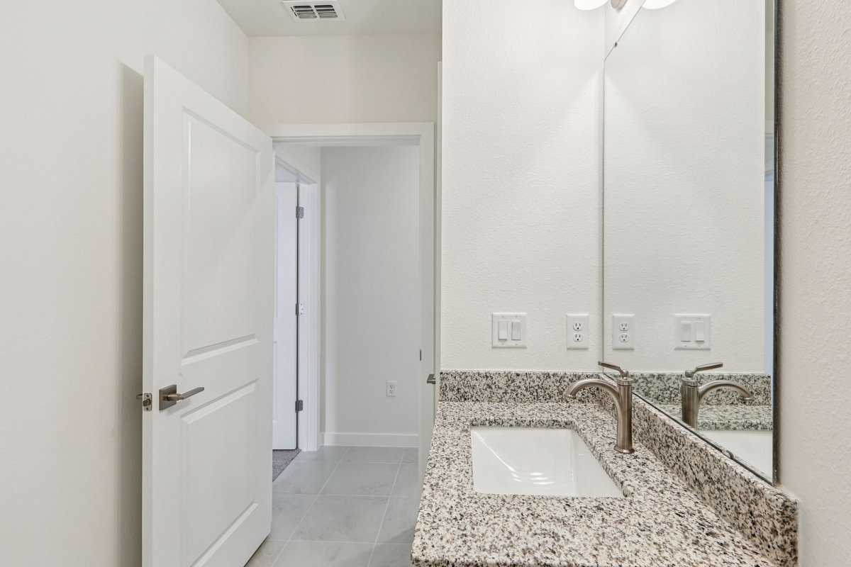 Bathroom with granite countertop and double sink