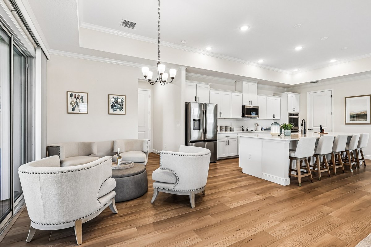 Open kitchen and lounge area with sliding doors in a Palm Bay builder home