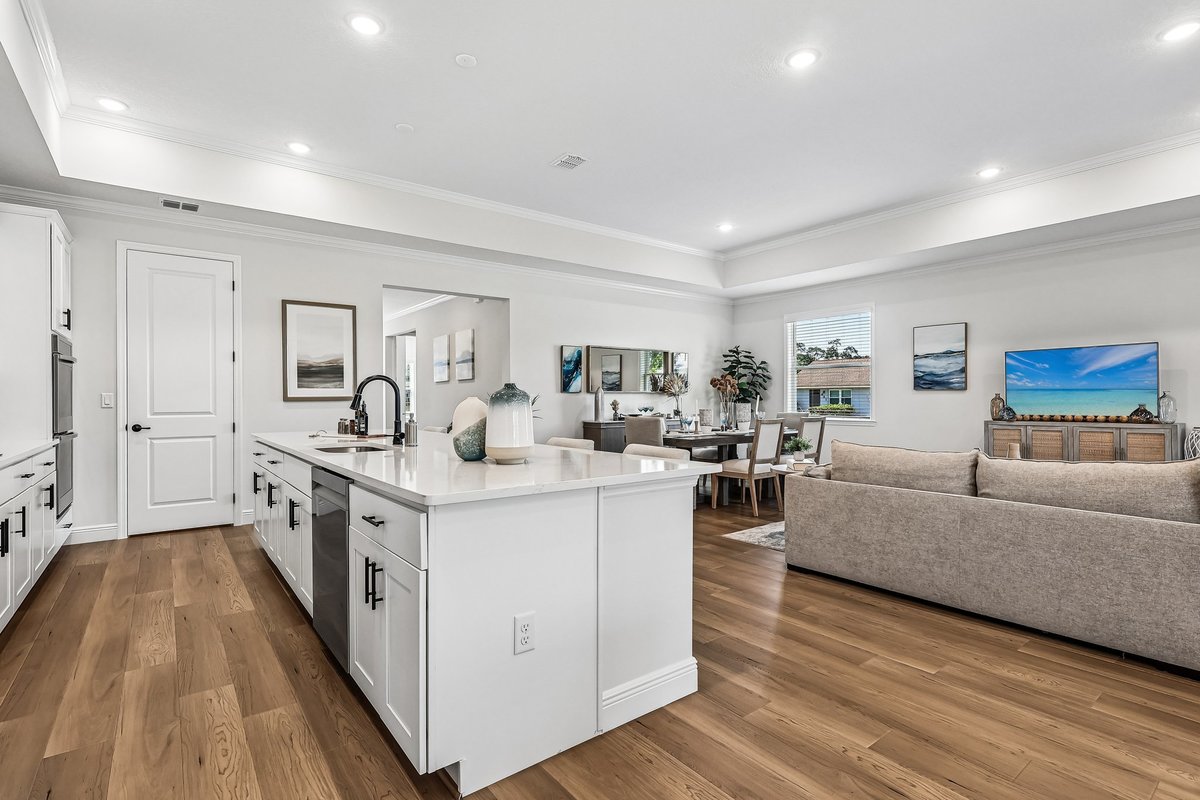 Open kitchen and lounge area with sliding doors in a Palm Bay builder home