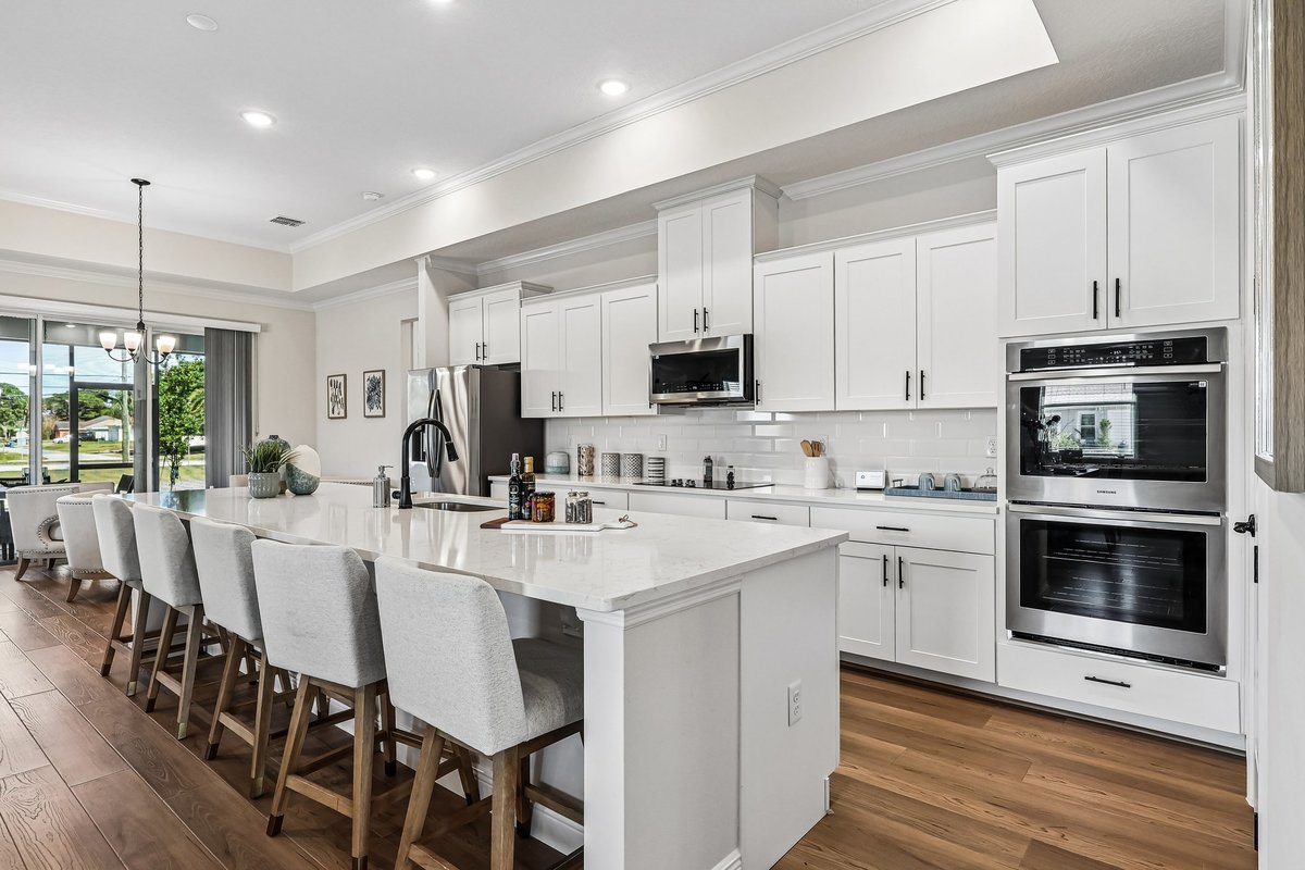 Large white kitchen island with bar seating in Palm Bay FL new construction home