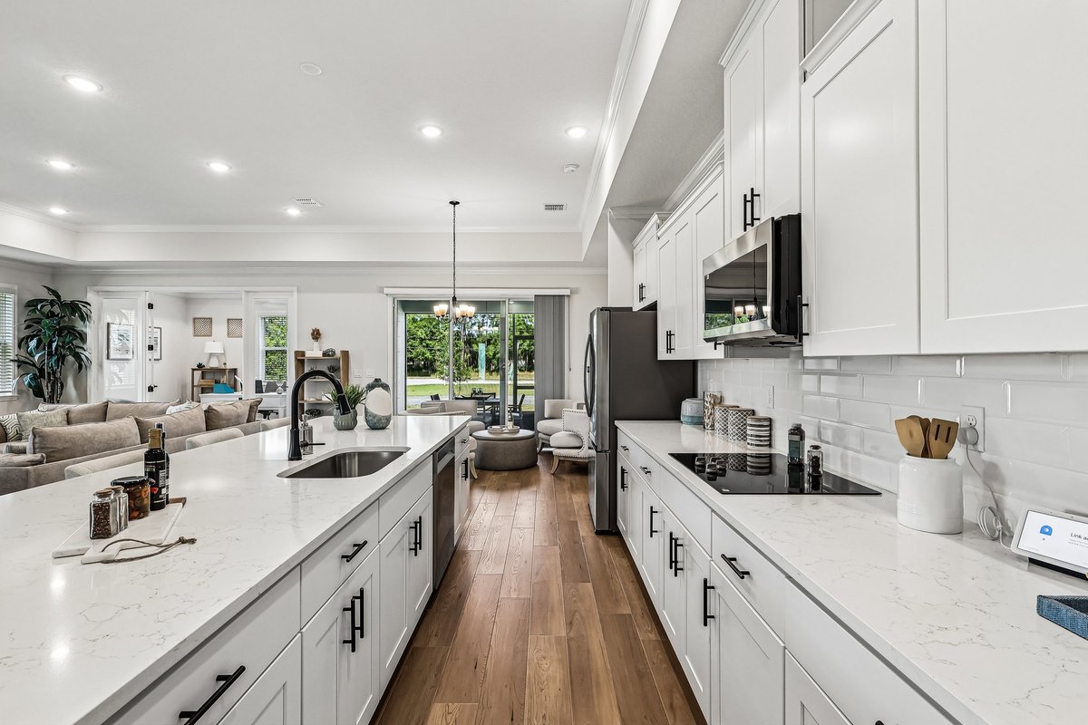 White kitchen with stainless steel appliances and black hardware in Palm Bay FL