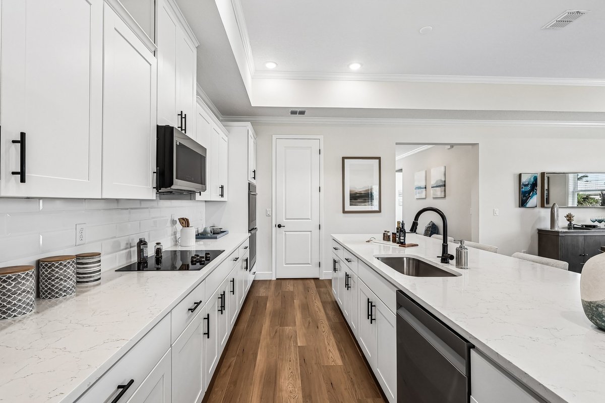 White kitchen with stainless steel appliances and black hardware in Palm Bay FL
