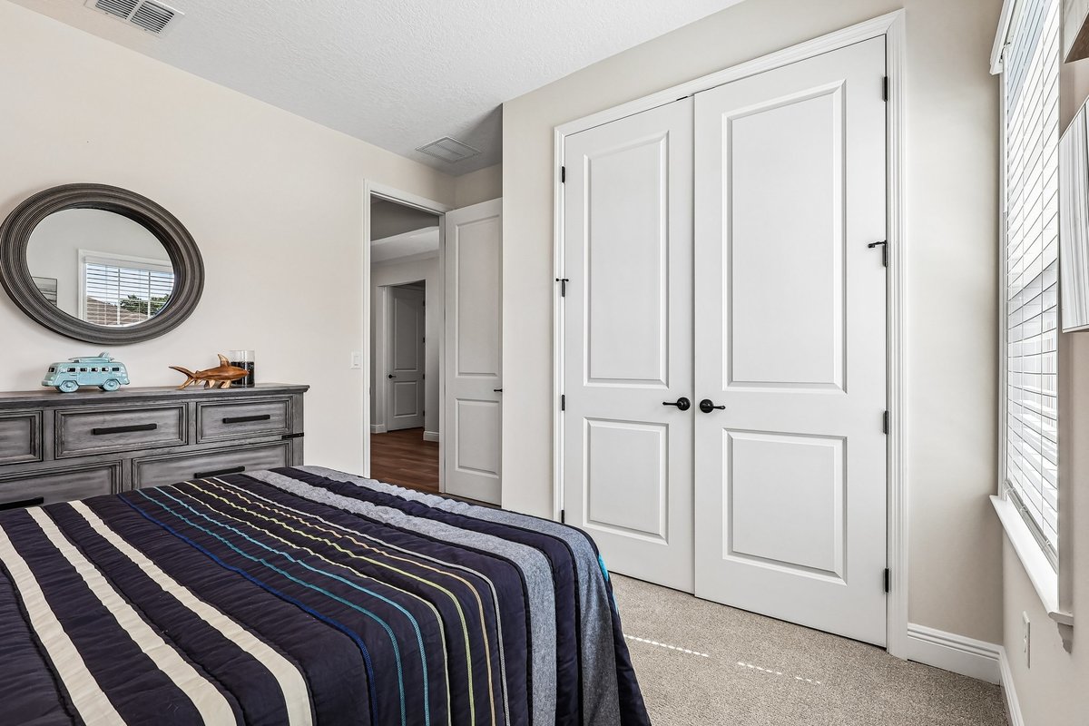 Staged coastal bedroom with blue accents in Palm Bay FL