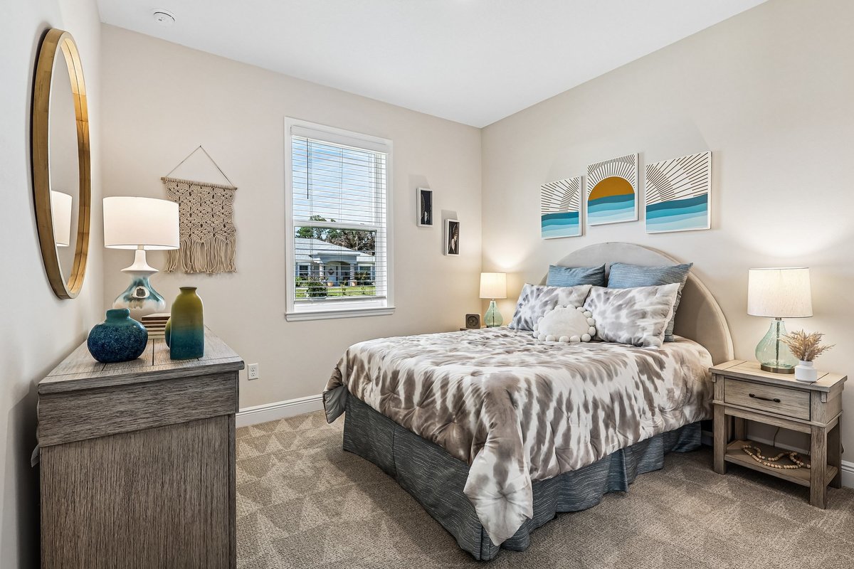 Staged bedroom with coastal artwork and neutral decor in Palm Bay FL