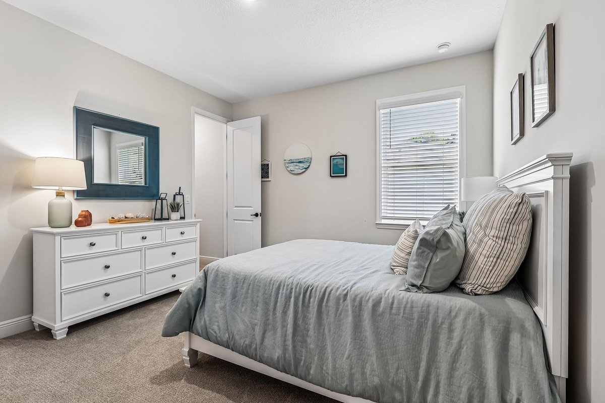 Secondary bedroom with white furniture and natural light in Palm Bay FL