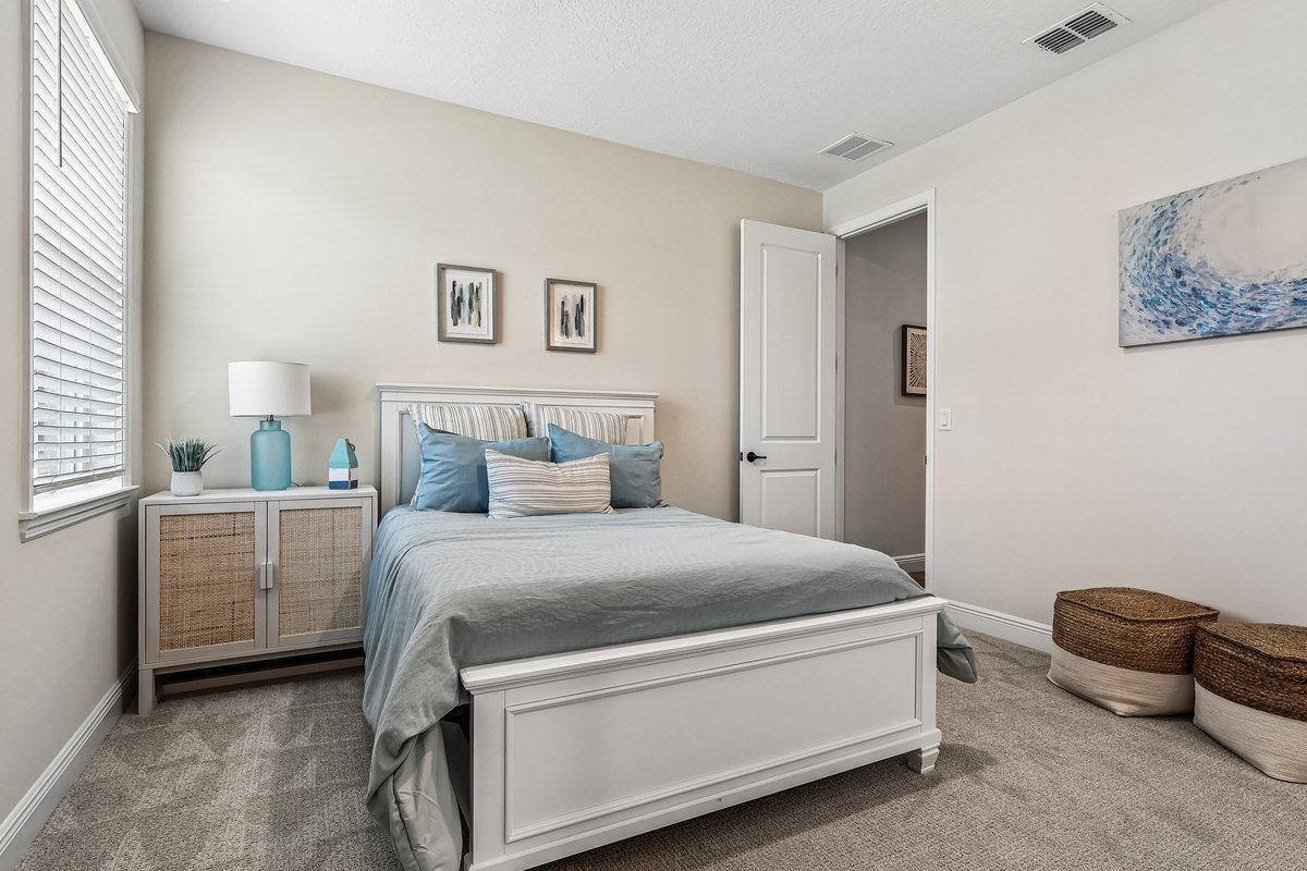 Secondary bedroom with white furniture and natural light in Palm Bay FL