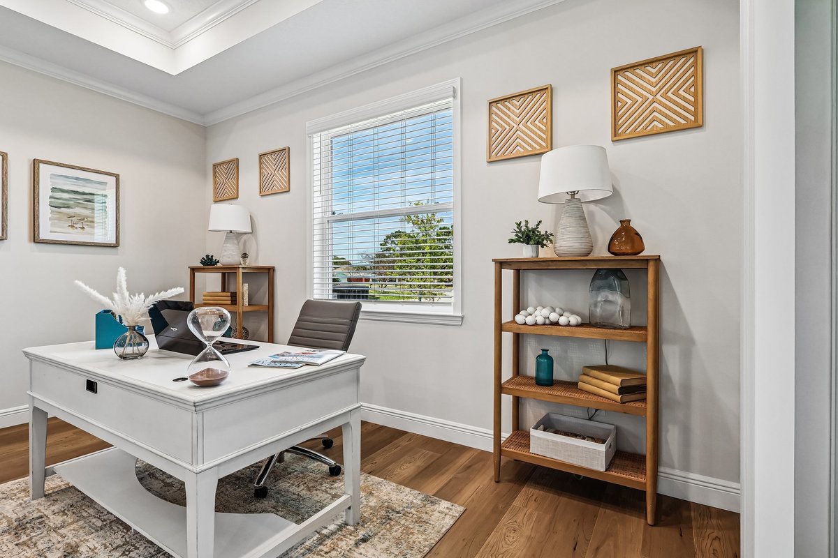 Home office with glass doors and view into open living area in Palm Bay FL
