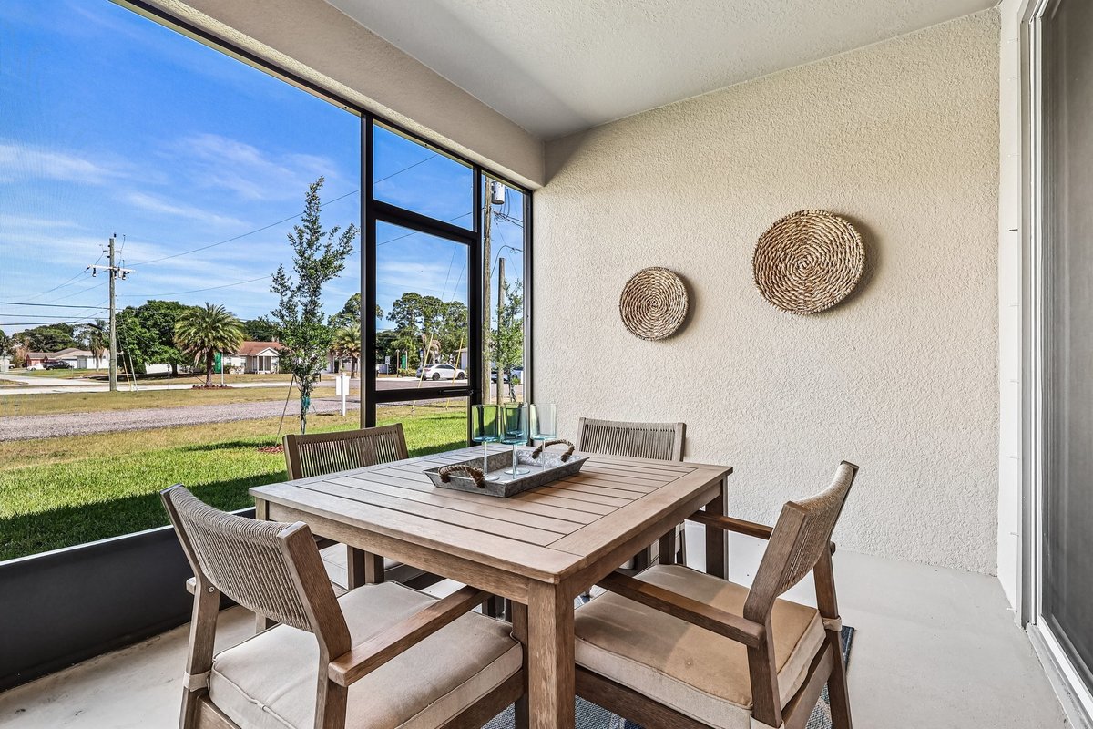 Covered patio with outdoor dining furniture in Palm Bay FL home