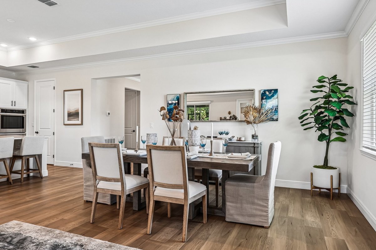 Staged dining area with coastal decor in a Palm Bay model home