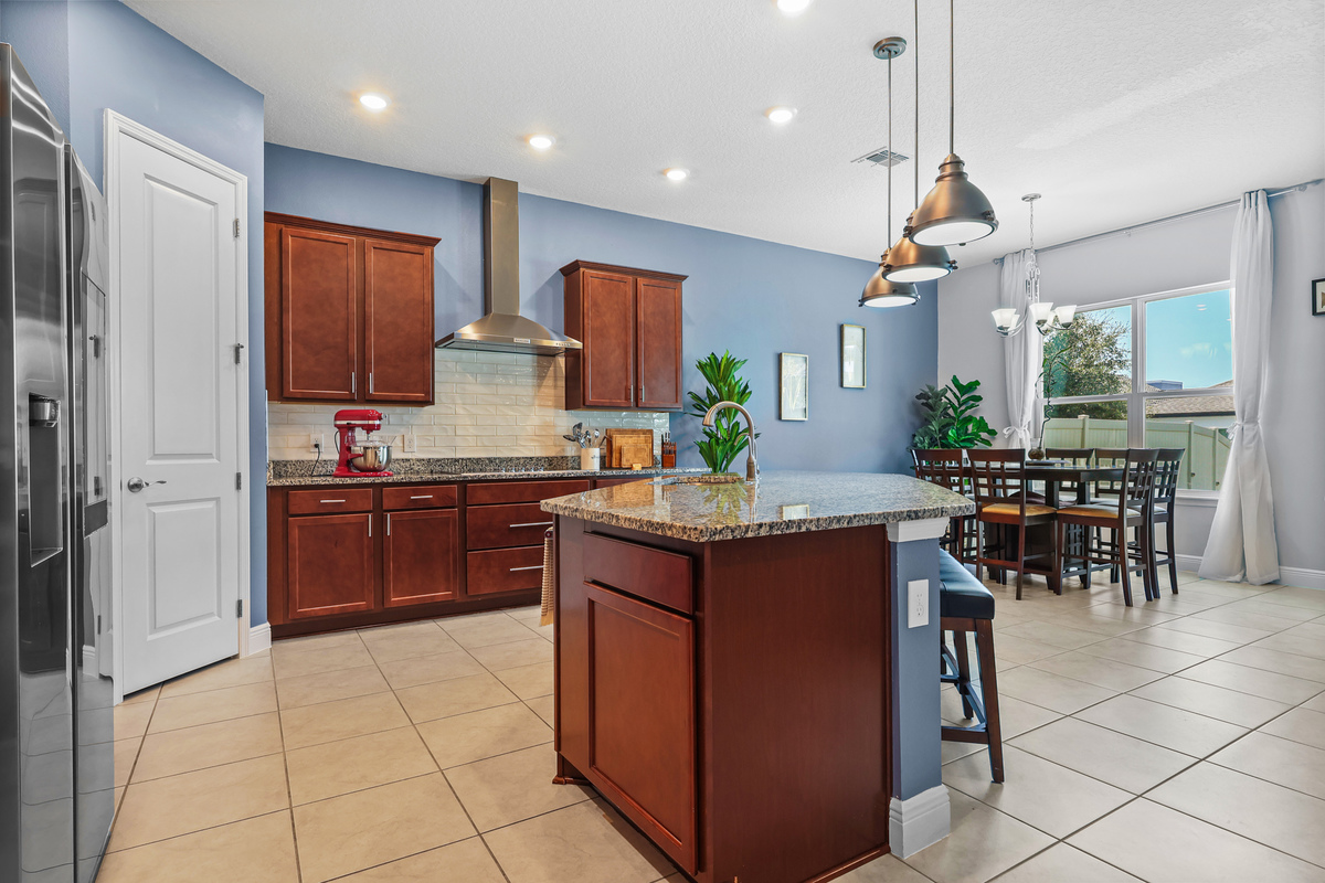 The kitchen shows functional space, warm cabinetry, and buyer-friendly layout.