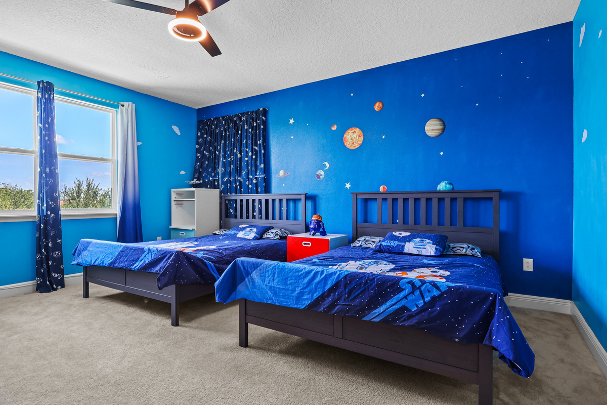Large primary bedroom with balcony doors in Winter Garden FL home