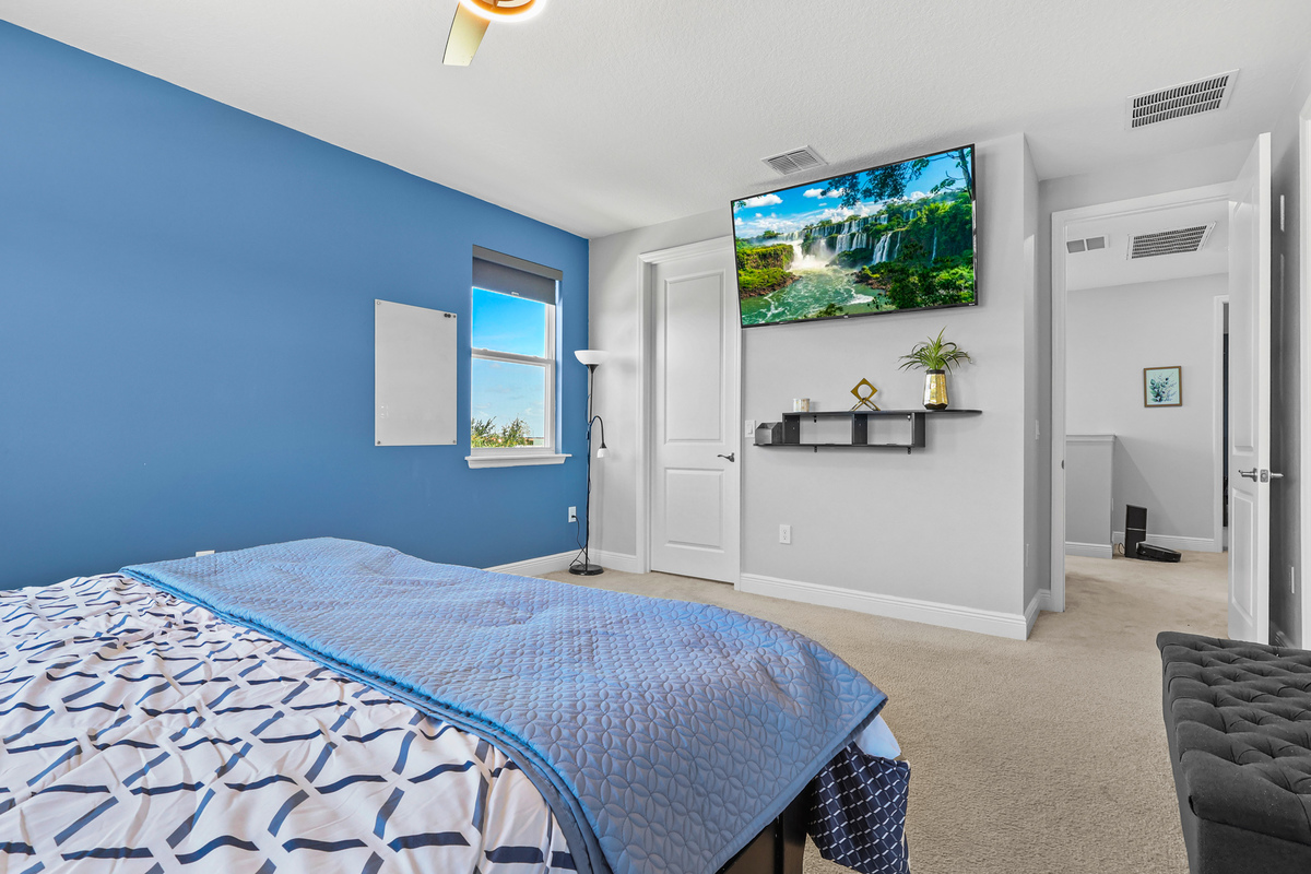The primary bedroom shows scale, natural light, and access to outdoor space.