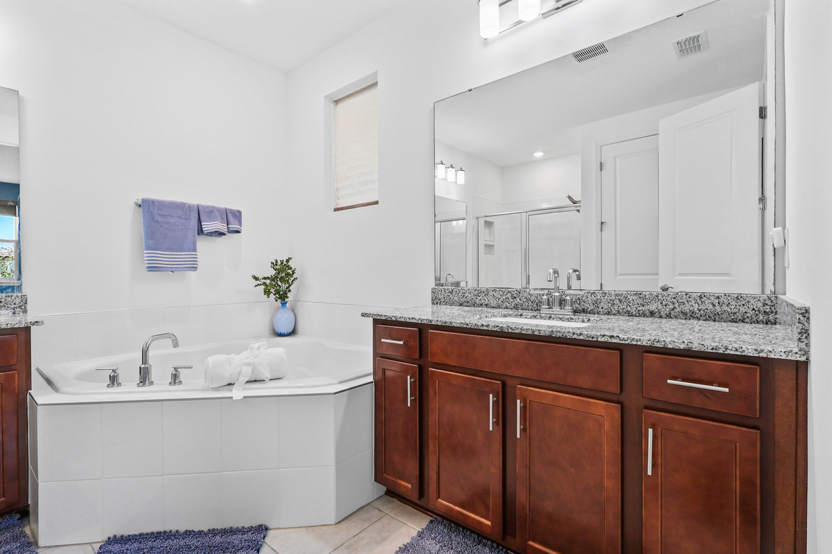 The primary bedroom shows scale, natural light, and access to outdoor space.