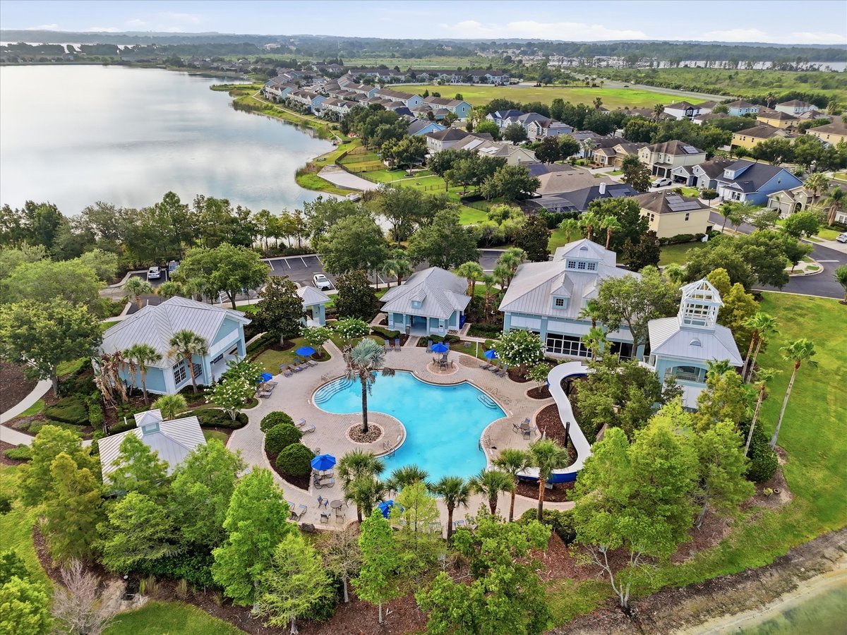 Aerial view of lake, clubhouse, pool, and courts in Groveland FL