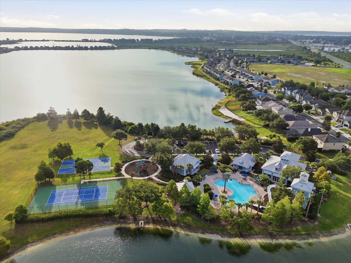 Aerial view of lake, clubhouse, pool, and courts in Groveland FL