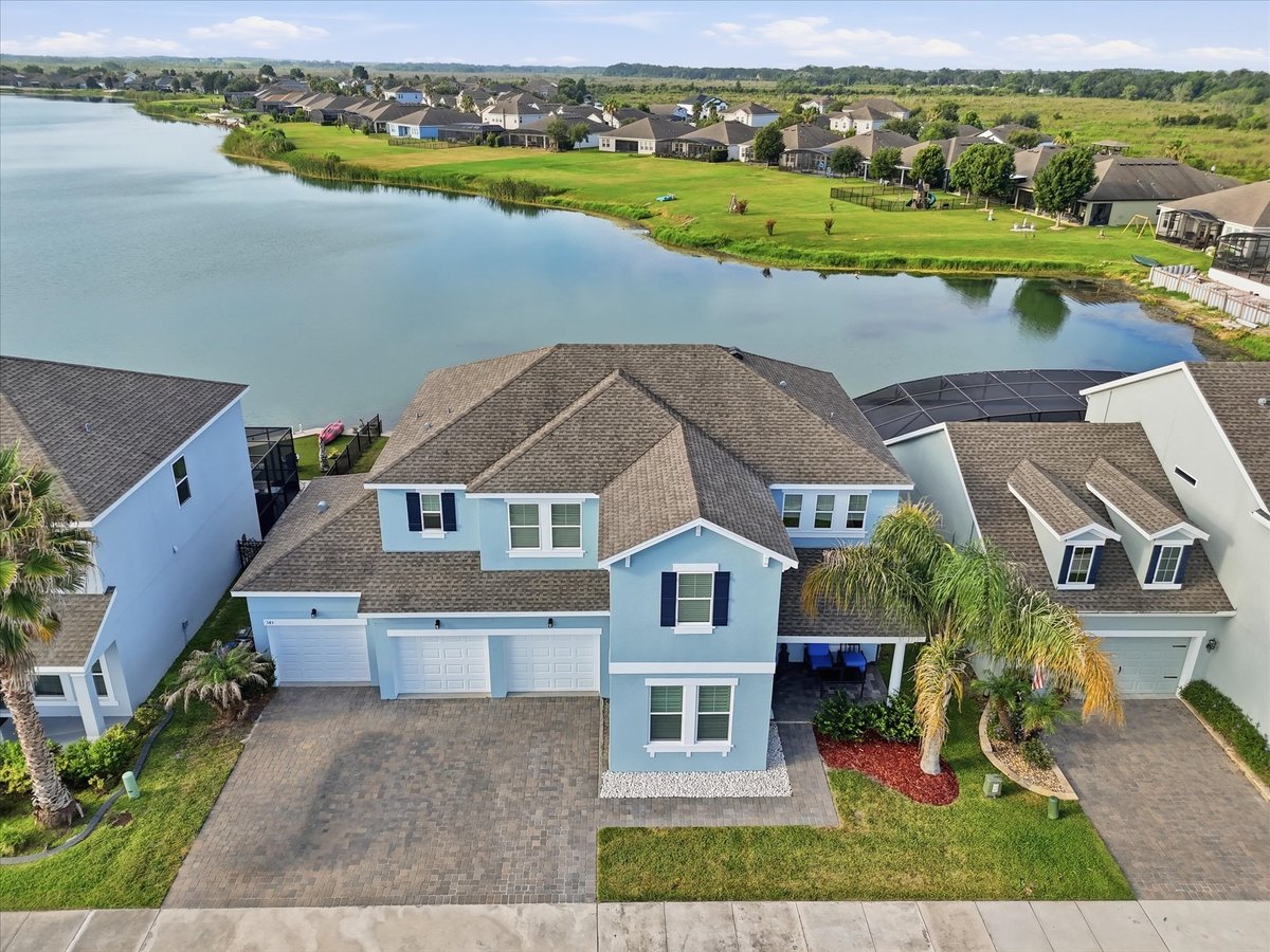Rear aerial view of 343 Blue Cypress Dr facing the water in Groveland FL