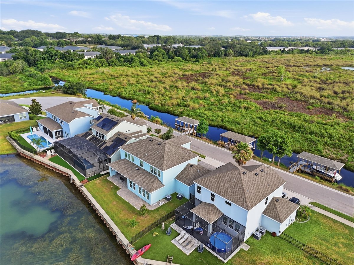 Aerial front view of waterfront home at 343 Blue Cypress Dr in Groveland FL