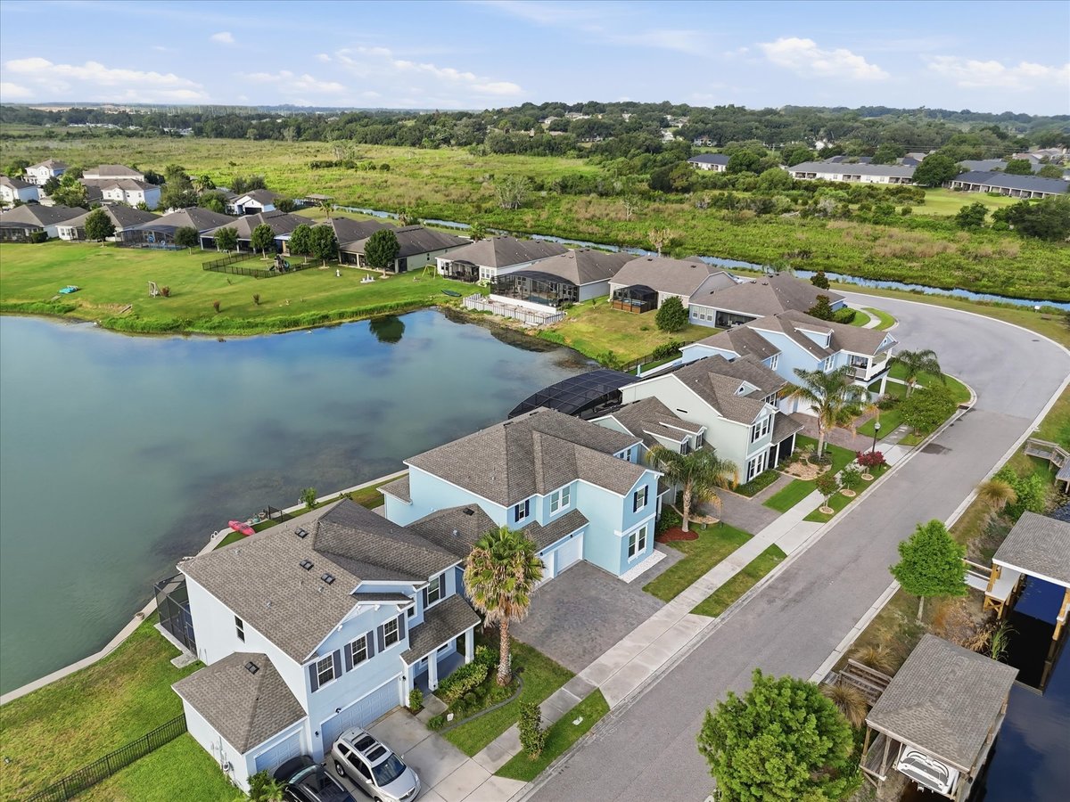 Aerial front view of waterfront home at 343 Blue Cypress Dr in Groveland FL