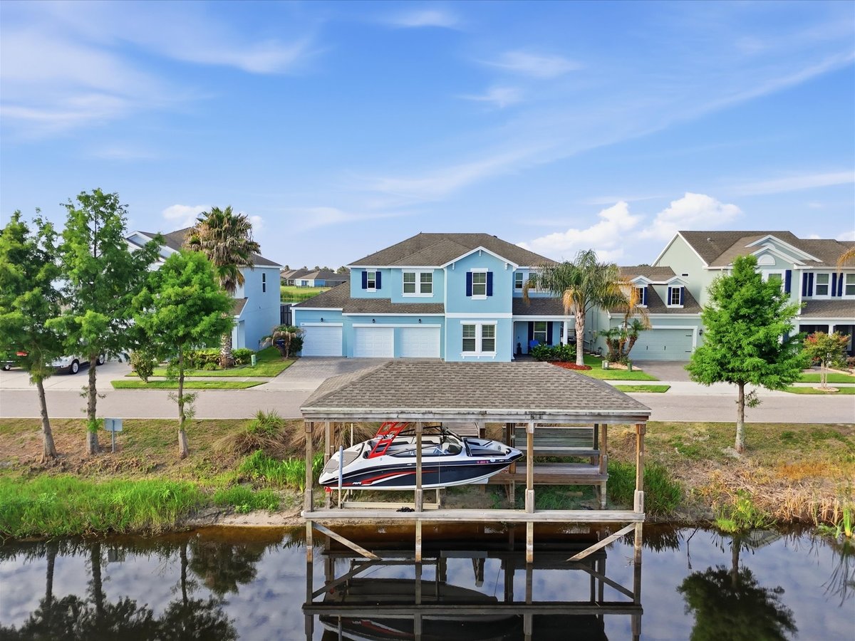 Drone photo showing waterfront home and covered dock in Groveland FL