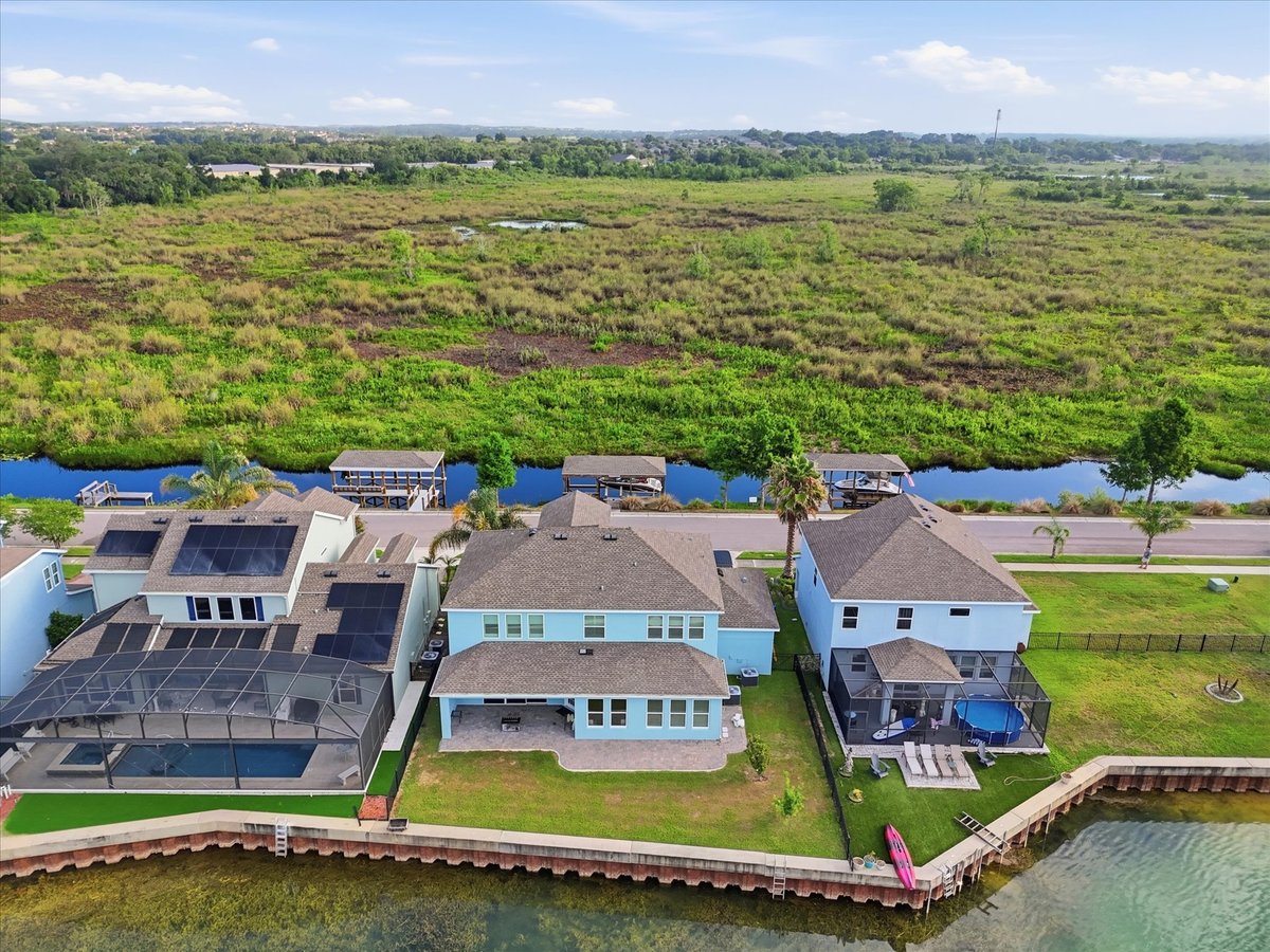 Aerial view of Groveland waterfront neighborhood with lake and homes