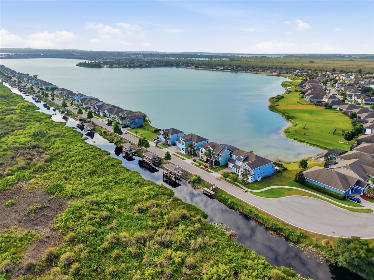 Aerial view of Groveland waterfront neighborhood with lake and homes