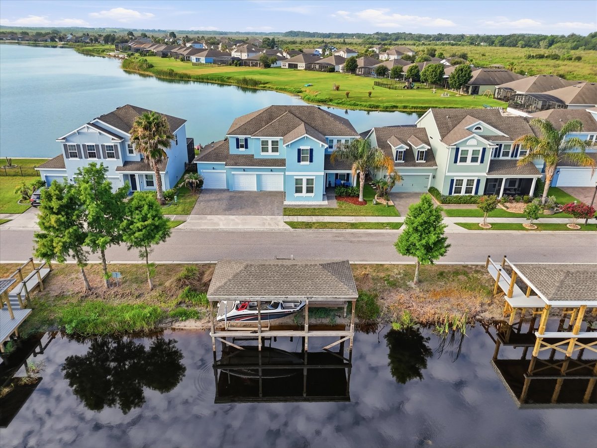 Drone photo showing waterfront home and covered dock in Groveland FL