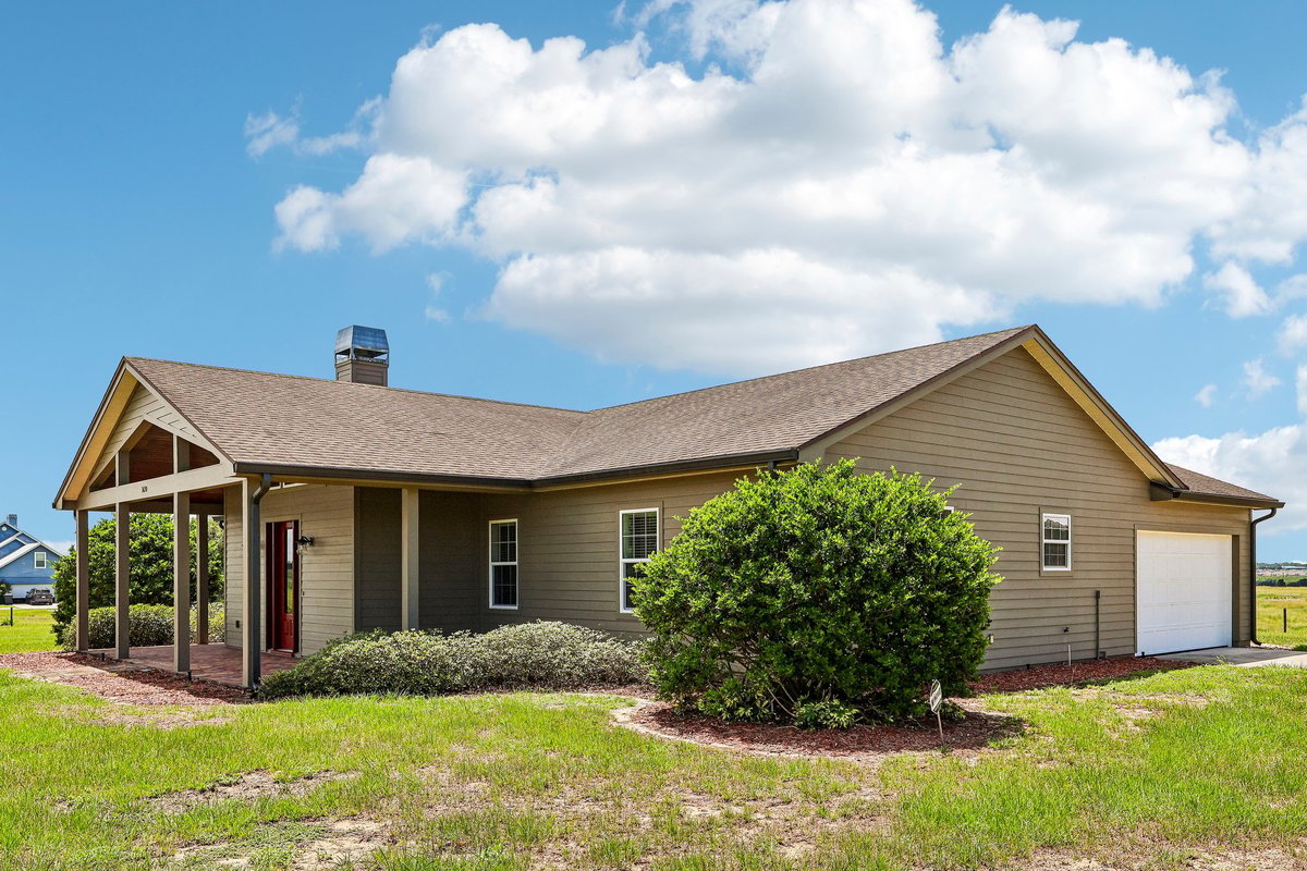 Corner entry with red door at custom Haines City acreage home