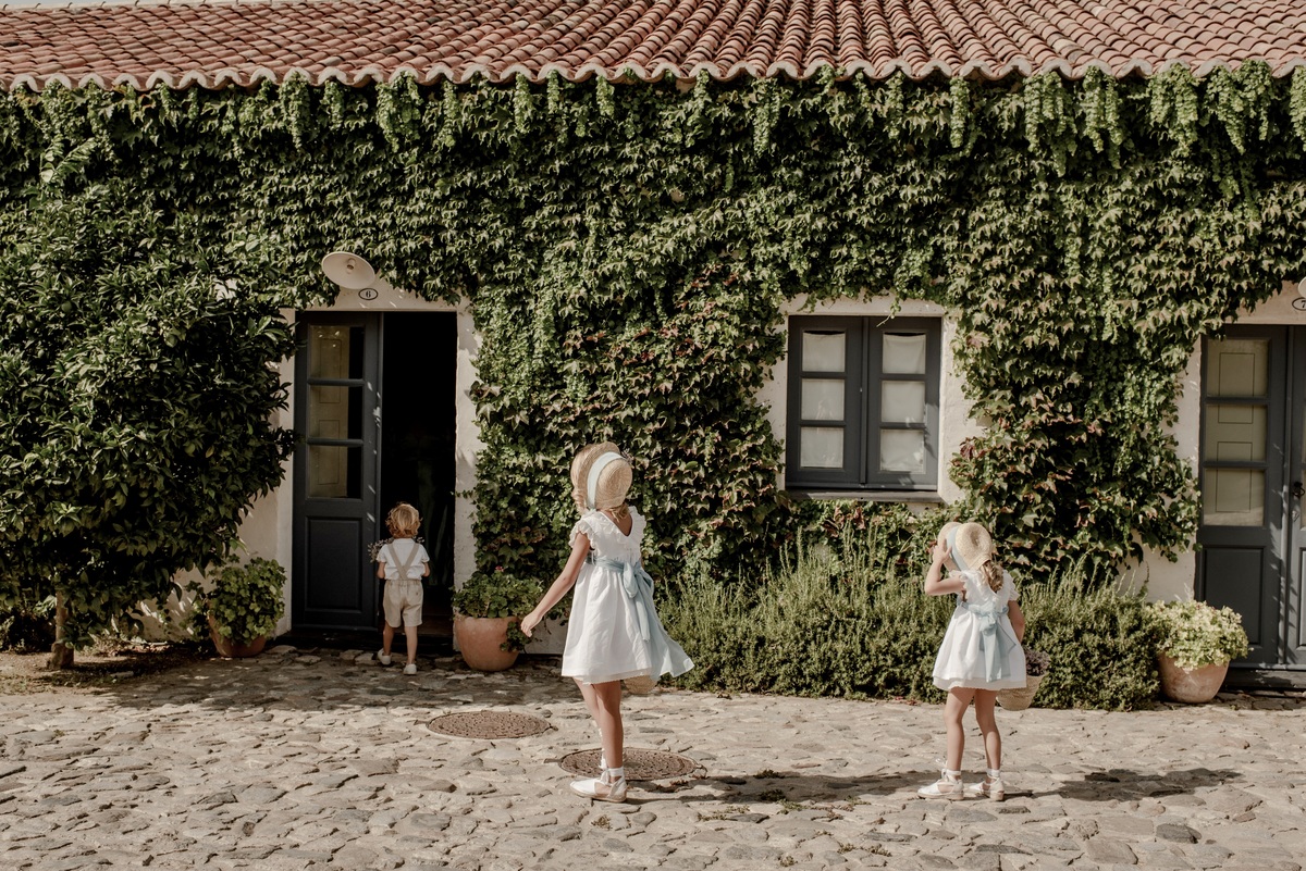 Children playing outside the wedding venue at a destination wedding in Portugal.