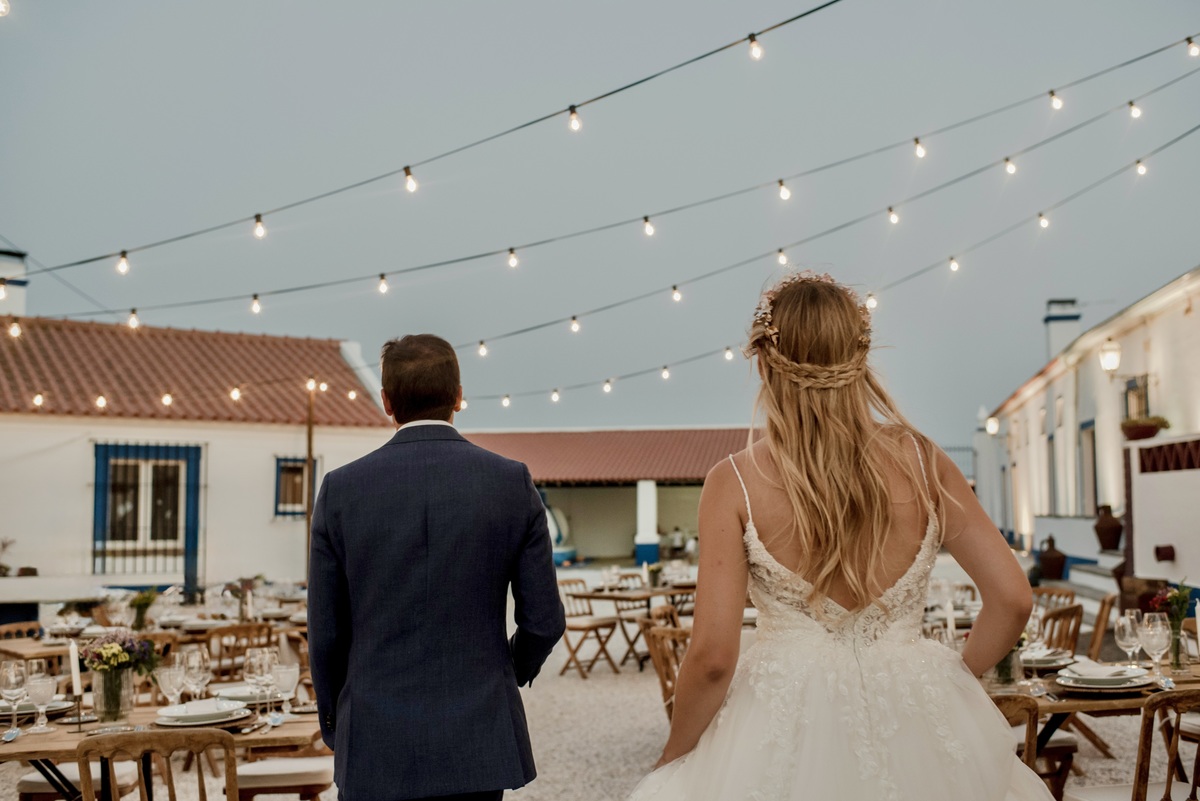 Bride and groom walking towards the dinner with their backs to the camera at a destination wedding.