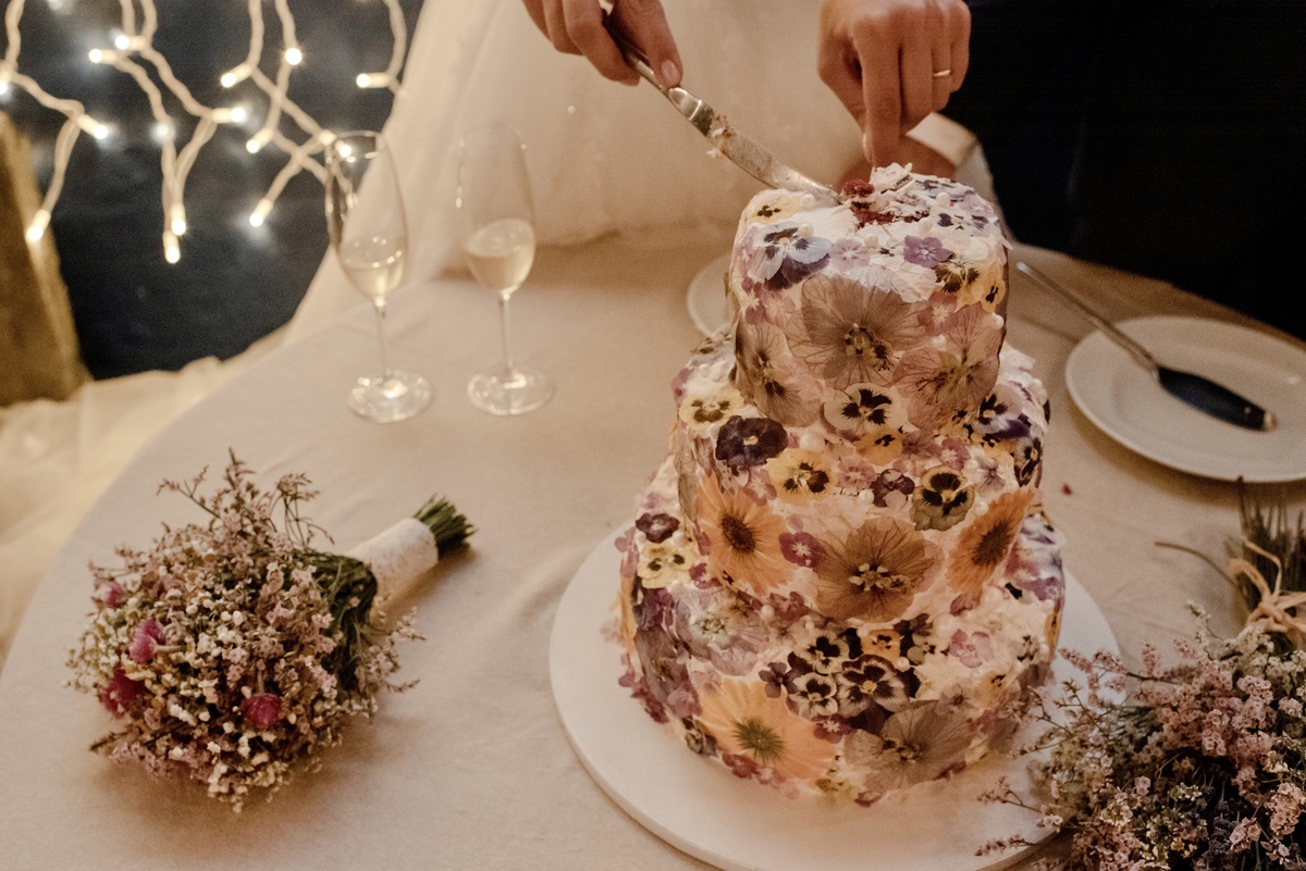 Bride cutting the wedding cake with groom at a destination wedding in Alentejo, Portugal.