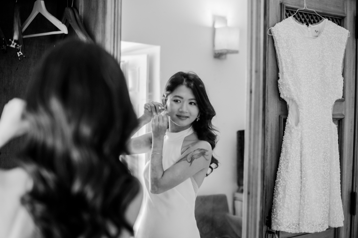 Bride-smilling-while-puttings-wedding-earings