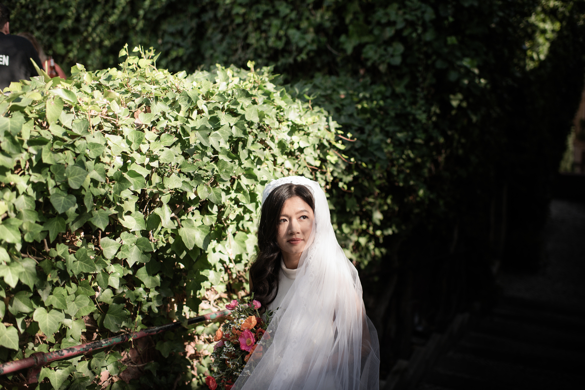 Bride-with-her-wedding-dress-in-a-sunny-garden 